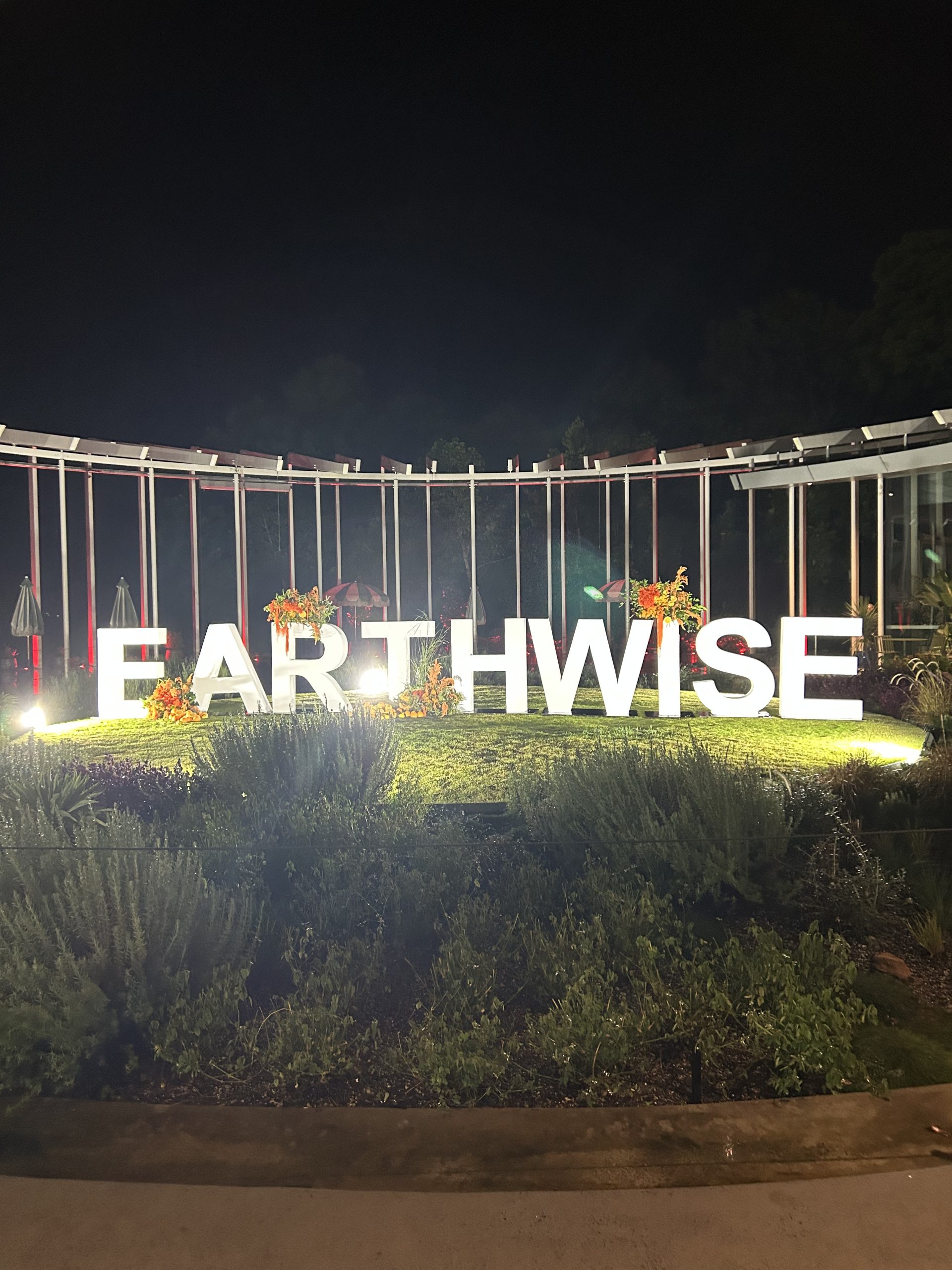 Illuminated white 3D Earthwise letters glowing at night, fabricated by Mega 3D Signs